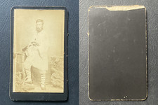 Man wearing laced sandals gaétanes pouring wine, belted gun