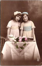 PORTRAIT OF TWO ADORABLE GIRLS : HAVING TEA AND CAKE : ALFRED NOYER :  (1916)
