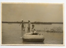 Portrait of young woman swimsuit inflatable boat old photo year. 1960