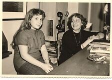 Women sitting desk standard phone - old photo year. 1950 60