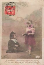 CP LITTLE GIRL OPEN BOOK LITTLE SCHOOLBOY SITTING ON BINDER