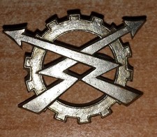 Insigne argenté béret unités REME (Royal Elec. & Mechanic. Eng. ) belge 45-49