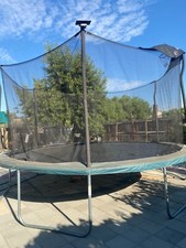 Green and black 15 ft trampoline with enclosure