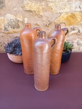 Trio of varnished stoneware bottles, terracotta bottles Wynand Fockink