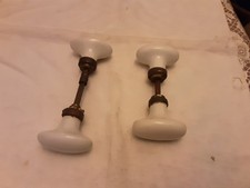4 ANTIQUE DOOR HANDLES. WHITE PORCELAIN